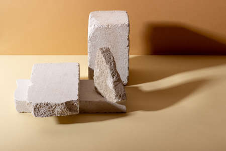 Background with geometric shapes made of concrete for cosmetic products. Rectangular podiums with shadows on a beige background. Blank mockup for product packaging presentationの写真素材