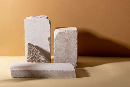 Background with geometric shapes made of concrete for cosmetic products. Rectangular podiums with...