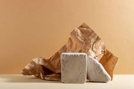 Background with geometric shapes made of concrete for cosmetic products. Rectangular podiums with shadows on a beige background. Blank mockup for product packaging presentationの写真素材