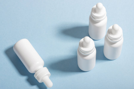 Set of white cosmetic bottles and jars with hard shadows. The concept of face and body care at home...