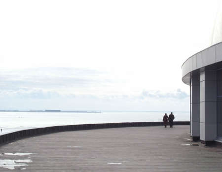 Two people are walking. Spring day, the Gulf of Finland. They go into the distance.の写真素材