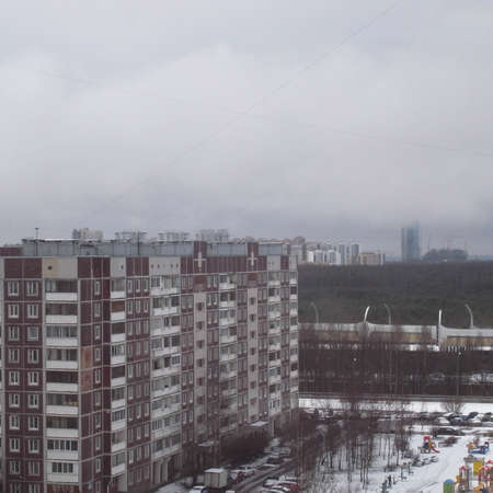The fog descends on the city. View from the window into the courtyard.の写真素材