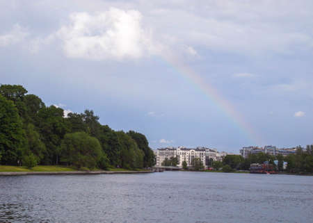 Rainbow over the city. Buildings against the sky. The city in summer.のeditorial素材