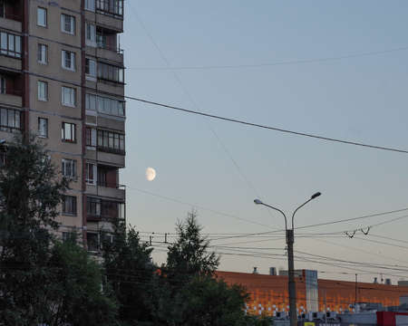The moon is in the wires. Evening sky and moon.の写真素材