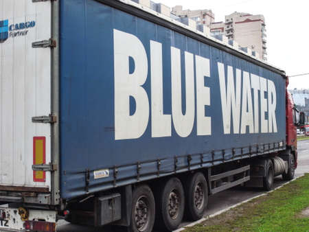Blue water in the city. A truck with a van.のeditorial素材