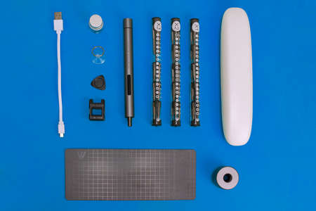 wowstick electric hand screwdriver for repair work and industry. tool on a white, yellow and blue backgroundのeditorial素材