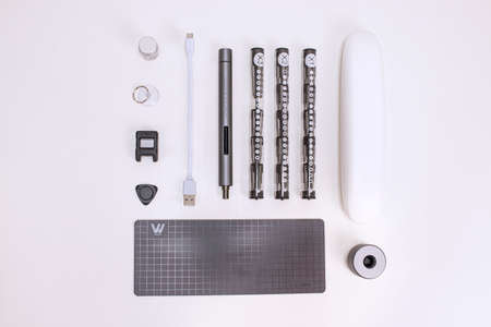 wowstick electric hand screwdriver for repair work and industry. tool on a white, yellow and blue backgroundのeditorial素材