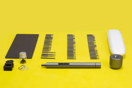 wowstick electric hand screwdriver for repair work and industry. tool on a white, yellow and blue backgroundのeditorial素材