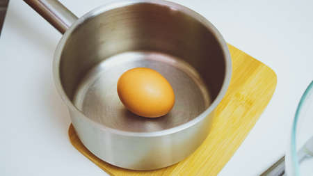Boiled chicken egg in a saucepan. Cooking process.の写真素材