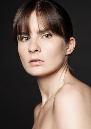 Beauty woman natural skin care on black background. Natural portrait. Healthy leaving. Classic photographyの写真素材