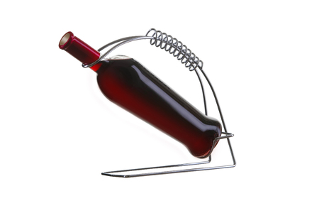 Bottle of red wine on holder with glass on white background. Perfect for bar and restaurantの写真素材
