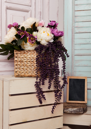 Picture frame and flowers on wooden box.Pink doors,flowers,apple boxes.Great for wedding interiorの写真素材