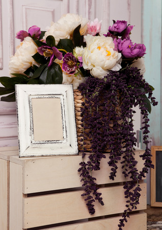 Picture frame and flowers on wooden box.Pink doors,flowers,apple boxes.Great for wedding interiorの写真素材
