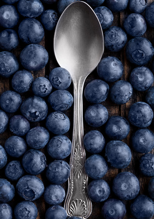Blueberries around spoon close up photo. Natural healthy food. Still life photographyの写真素材