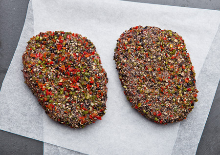 Beef raw steak  on stone board and cooking paper closeupの写真素材
