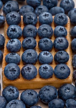Blueberries on top of sweet waffle on plate closeup. Still lifeの写真素材