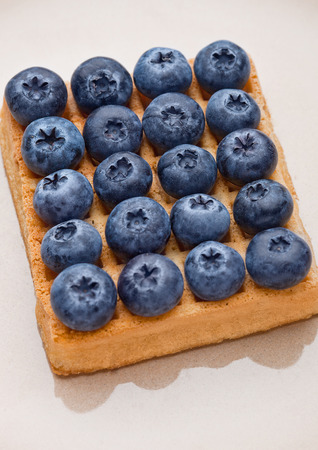 Blueberries on top of sweet waffle on plate closeup. Still lifeの写真素材