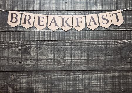 Breakfast sign with paper letter on wooden table. For text belowの写真素材