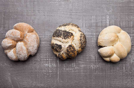 Fresh bread rolls for breakfast morning on wooden table in cafeの写真素材