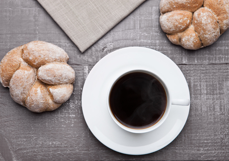 coffee cup with bread roll for breakfast morning in cafeの写真素材