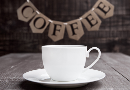 Coffee cup espresso  hot white on wooden board with lettersの写真素材