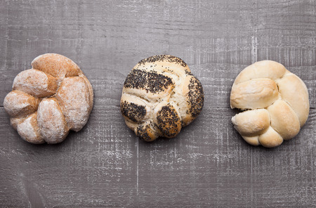 Fresh bread rolls for breakfast morning on wooden table in cafeの写真素材