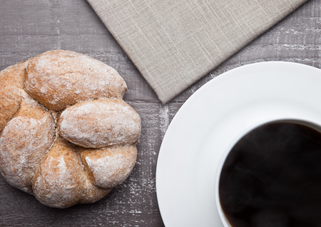 coffee cup with bread roll for breakfast morning in cafeの写真素材