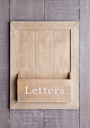 Wooden textured  board for letters and messages on wooden backgroundの写真素材