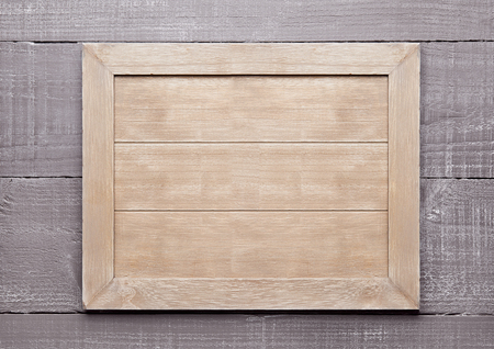 Wooden textured sign board for messages empty on wooden backgroundの写真素材
