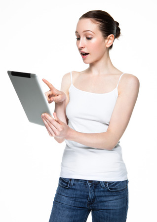 Beautiful woman browsing internet on tablet on white backgroundの写真素材