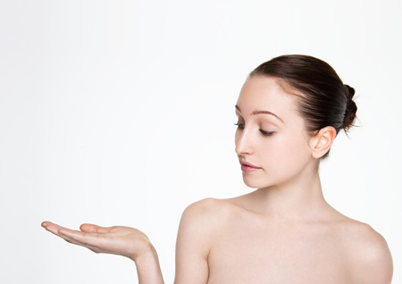 Beauty women natural makeup holding arm up for text on white backgroundの写真素材