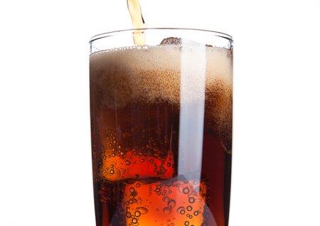Cola glass with ice cubes and bubbles on white backgroundの写真素材