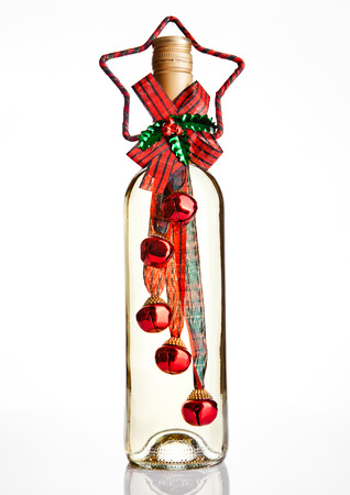 Bottle of white wine with christmas decoration  on white backgroundの写真素材