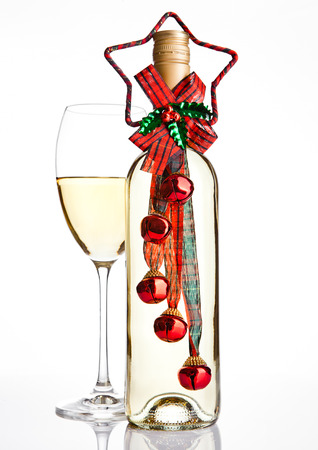 Bottle of white wine with christmas decoration  on white backgroundの写真素材
