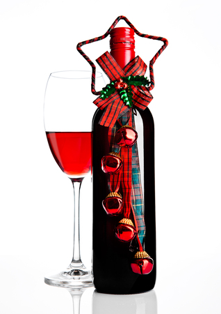 Bottle and glass of red wine christmas decoration on white backgroundの写真素材
