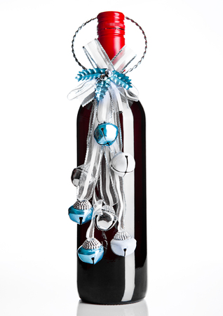 Bottle of red wine with christmas decoration blue on white backgroundの写真素材