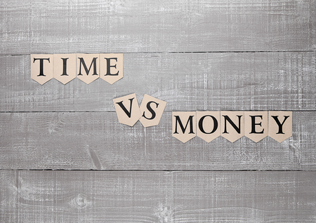 time vs money paper letters symbol motivation sign on wooden boardの写真素材