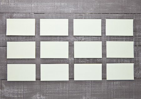 Yellow sticky note paper blank on wooden board. For text