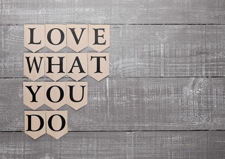 love what you do motivation symbol on wooden boardの写真素材