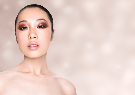 Beauty asian woman healthy cosmetic makeup portrait on beige bokeh backgroundの写真素材