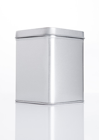 Empty tea steel container jar on white background with reflectionの写真素材