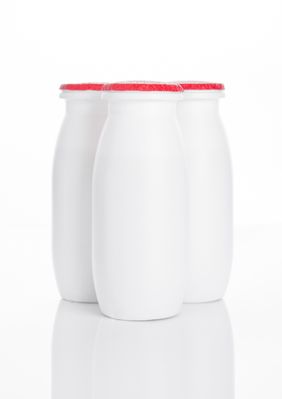 Yogurt containers healthy vitamin drink on white backgroundの写真素材