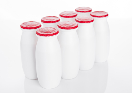 Yogurt containers healthy vitamin drink on white backgroundの写真素材