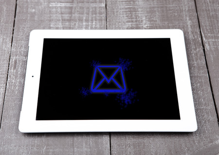 Graphic tablet computer pc gadget letter symbol blue on wooden boardの写真素材