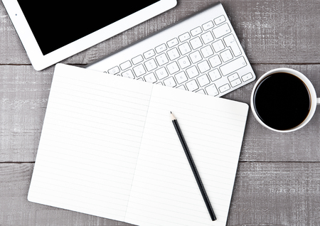 Keyboard with pencil and  coffee cup and tablet on office deskの写真素材