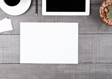 Graphic tablet with cactus paper sheet and coffee on office deskの写真素材