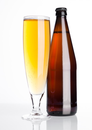 Glass of beer cider with bottle on white  backgroundの写真素材