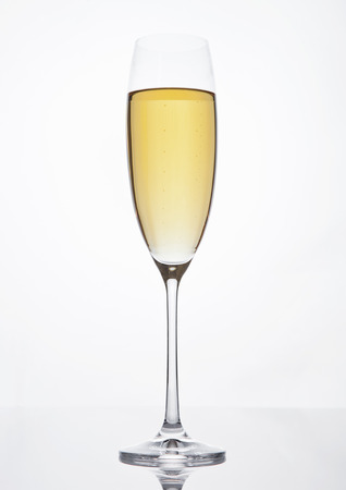 Champagne glass with bubbles on white backgroundの写真素材