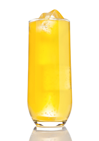 Glass of orange soda with ice cubes and bubbles with reflection on white backgroundの写真素材