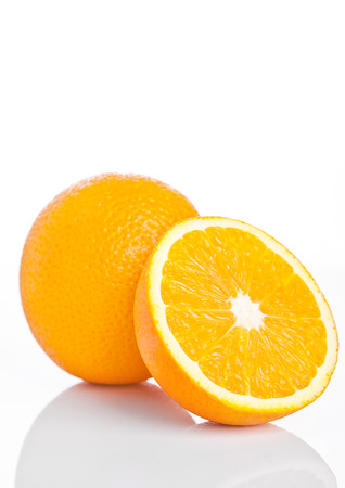 Healthy organic orange with slice on white backgroundの写真素材